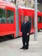 Seattle Mayor Greg nickels in front of the Inekon streetcar.